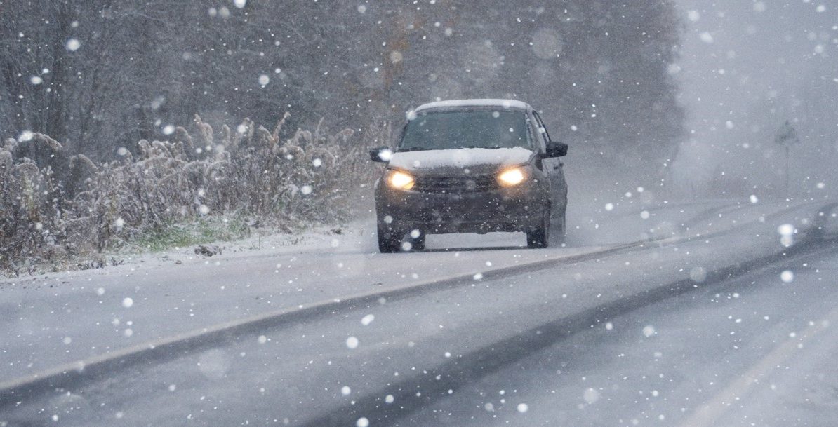 Car driving through a winter storm